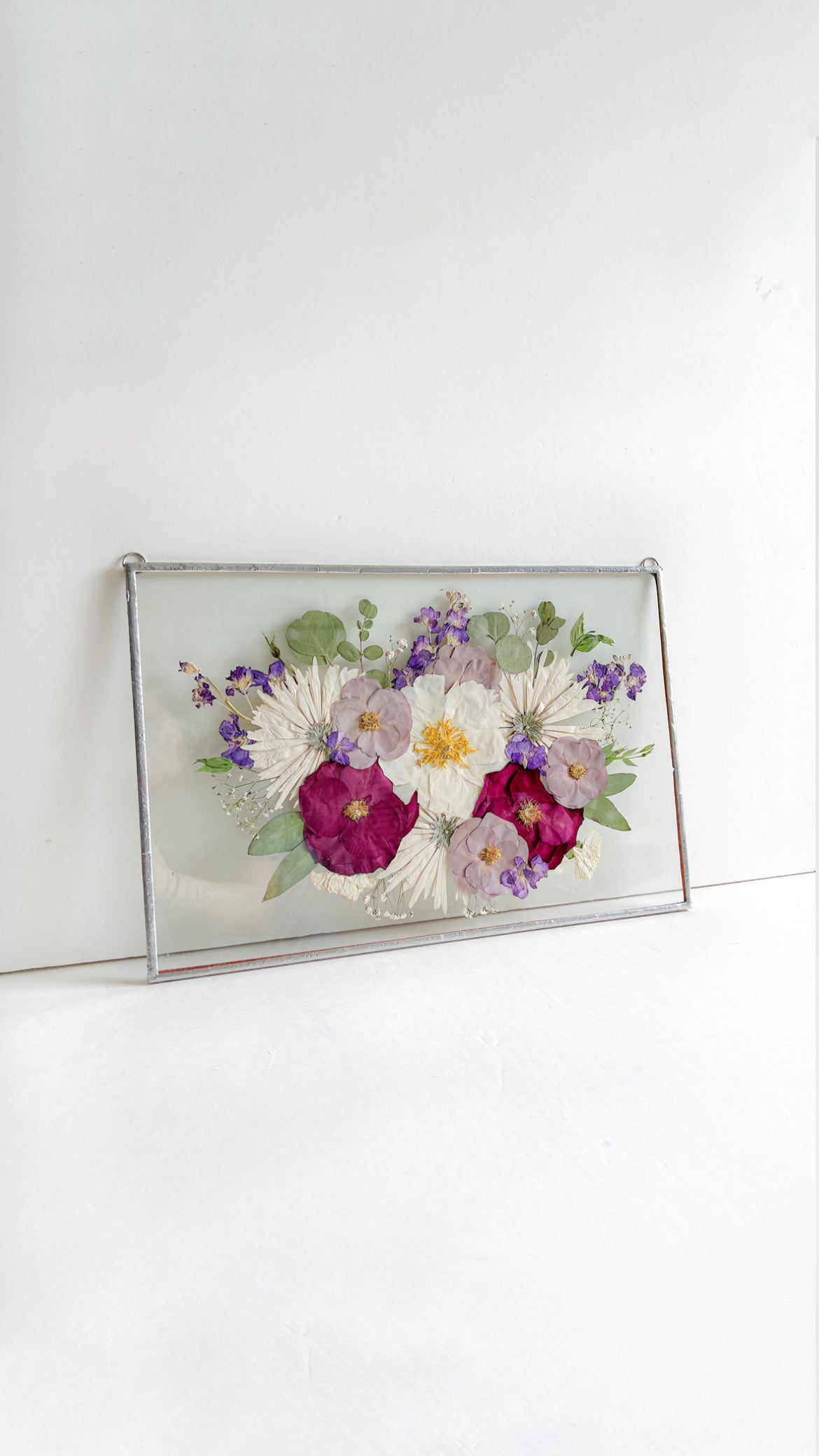 flowers preserved in glass frame