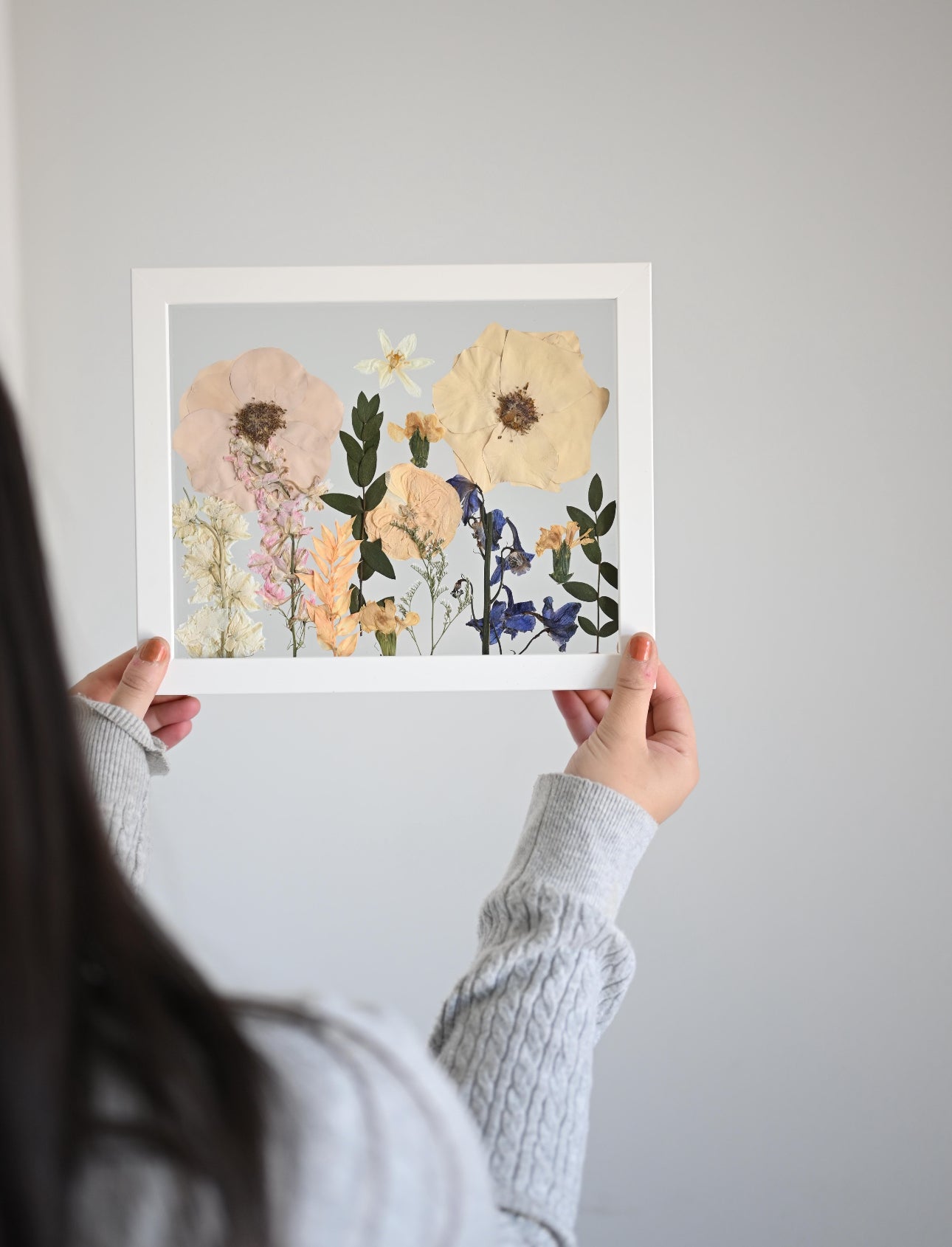 a frame with a floral arrangement 