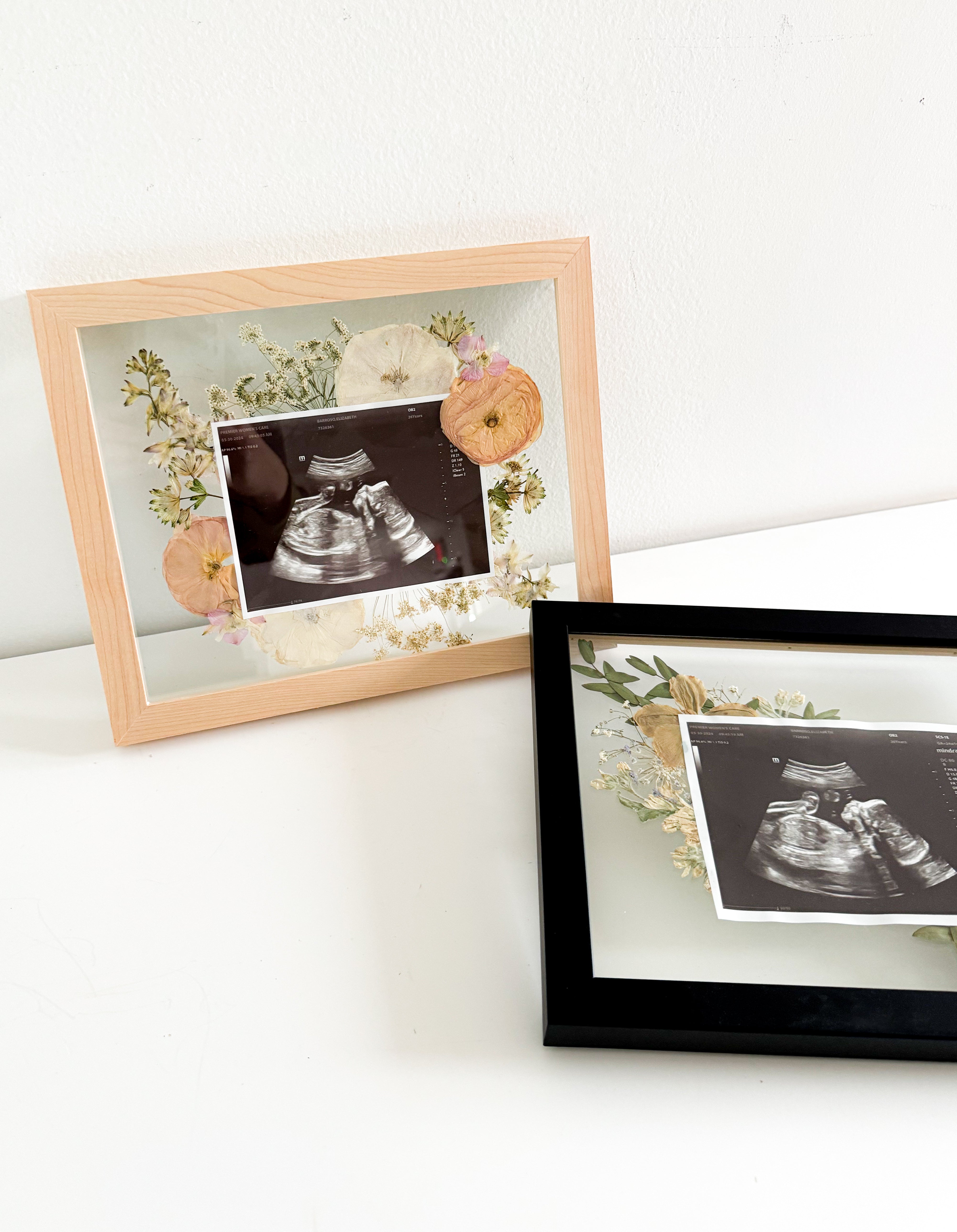 two Sonogram Frames with floral decor inside