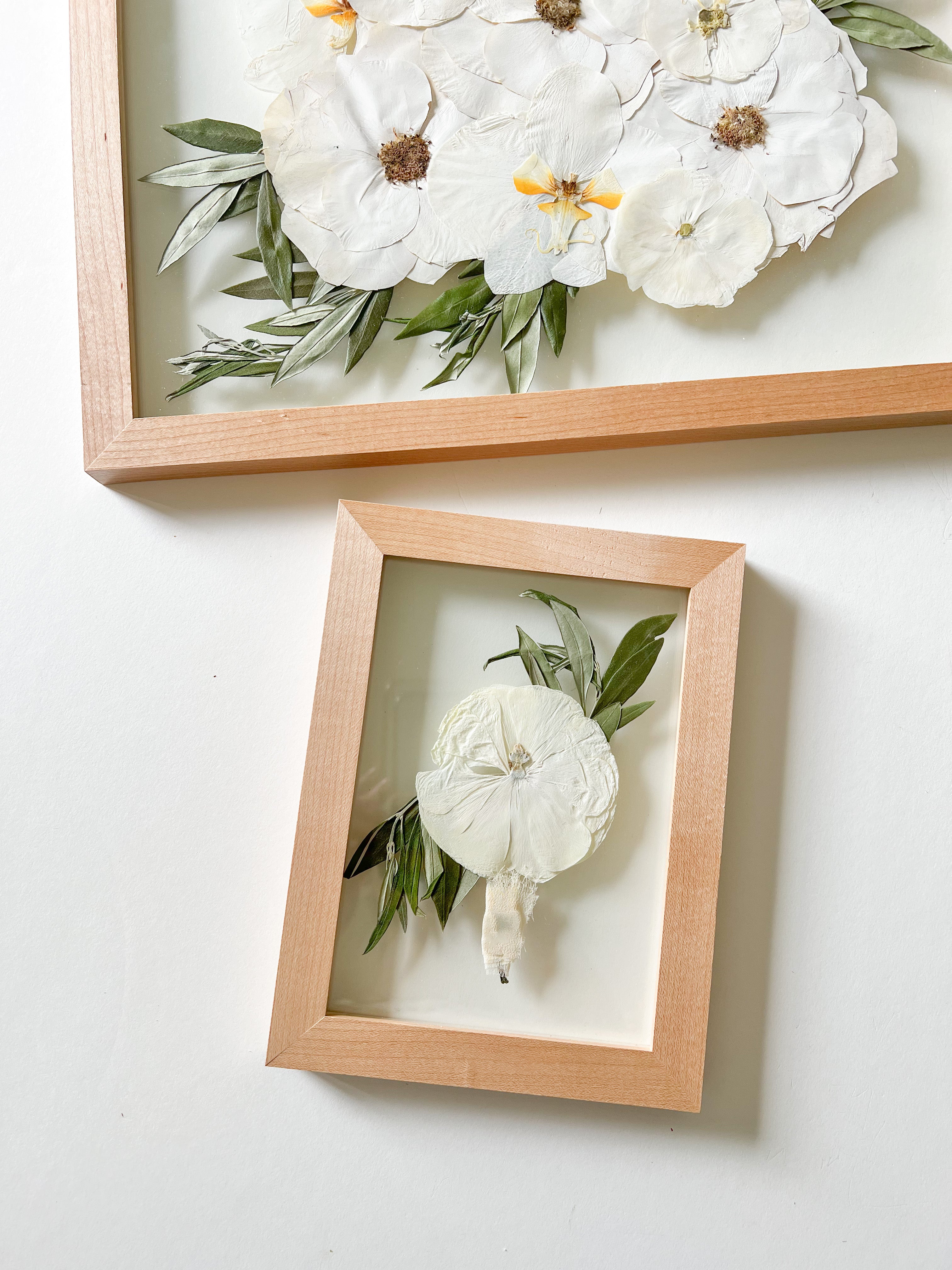 two white flower pressed frames