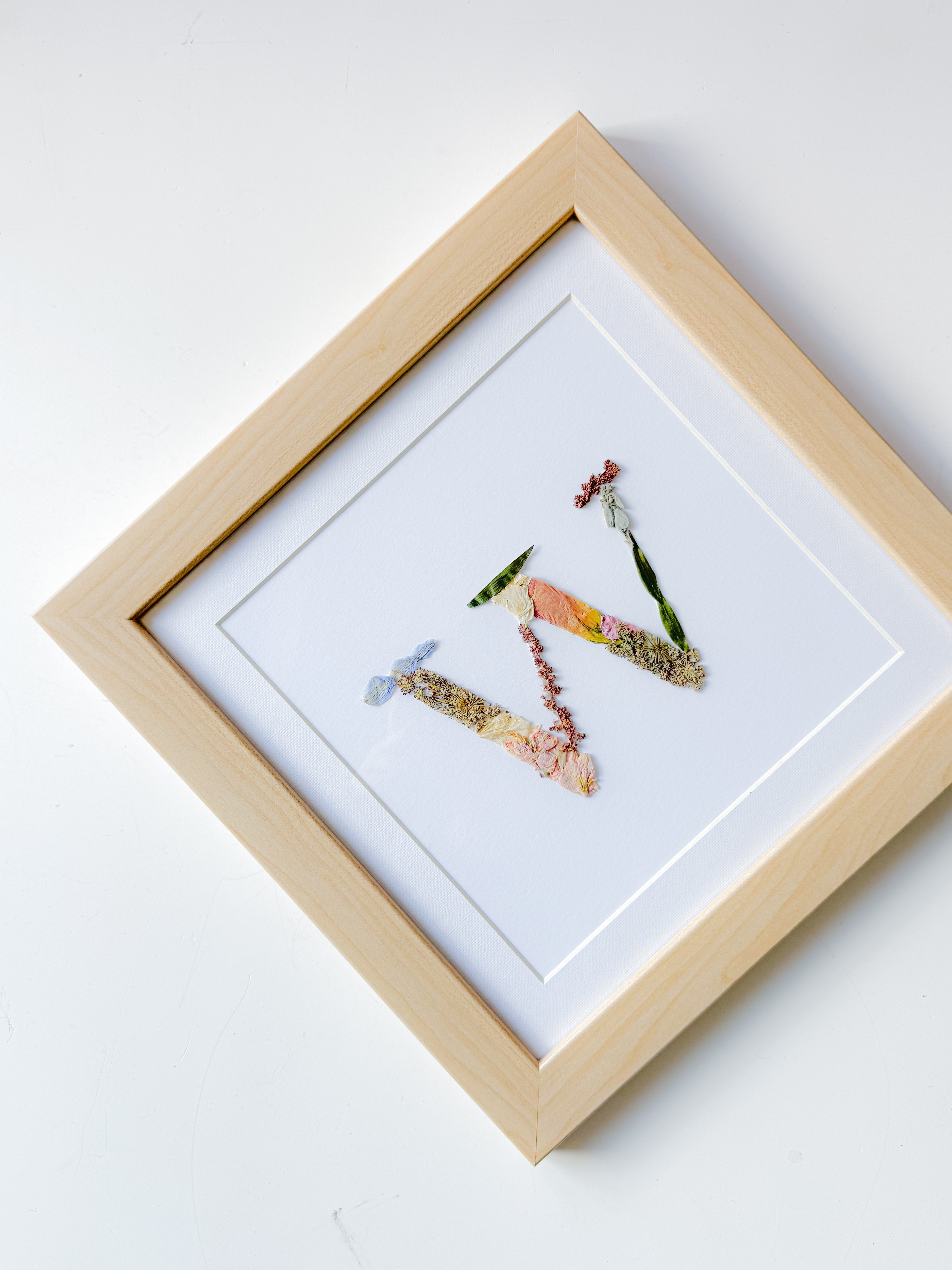 A floral letter design frame of preserved flowers